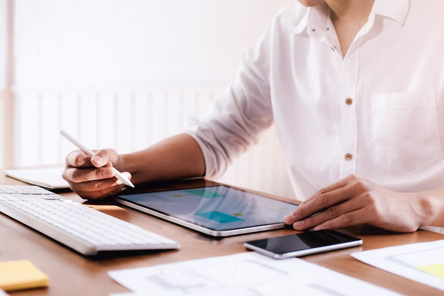 Professional reviewing digital quality documents on a tablet for Veeva Vault QualityDocs implementation and document management
